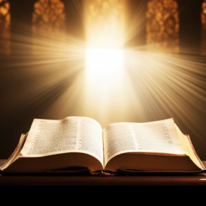 A Bible sits open on a lecturn with a stream of light coming in from the stained glass windows of a church.