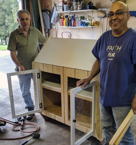 BAC members Rick Roxby and Ed Ferrer build the food pantry that serves the food insecure members of the local community.